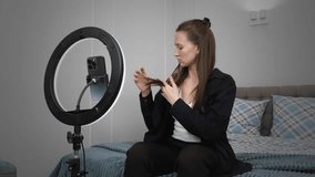 Young woman influencer recording video blog while creating content, using ring light for professional illumination and engaging social media followers from home setting. vertical video - Powered by Shutterstock - Get 15% off with code: PIKWIZARD15