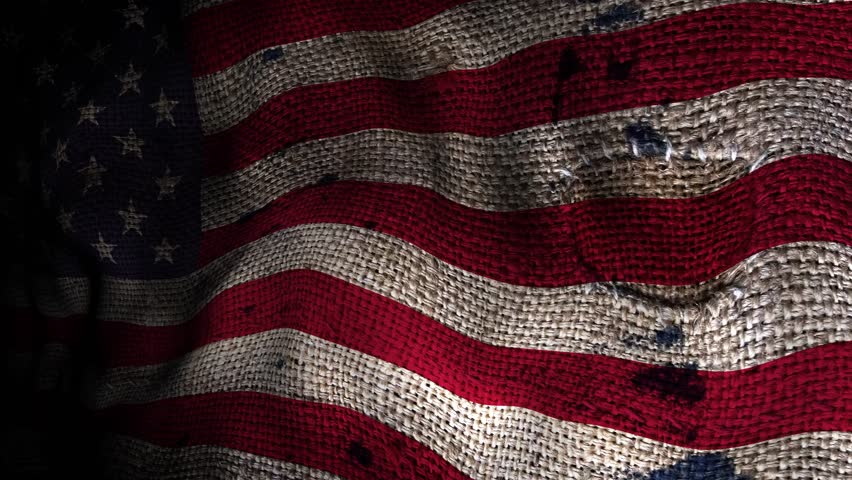 Seamless looping animation of the United States flag waving in the wind, with smooth, continuous motion and dramatic lighting that highlights the red, white, and blue colors.