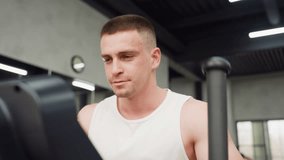 Focused gym enthusiast working on rowing machine in modern studio with large window and mirror reflection showing workout expression radiates determination and strength during intense cardio session - Powered by Shutterstock - Get 15% off with code: PIKWIZARD15