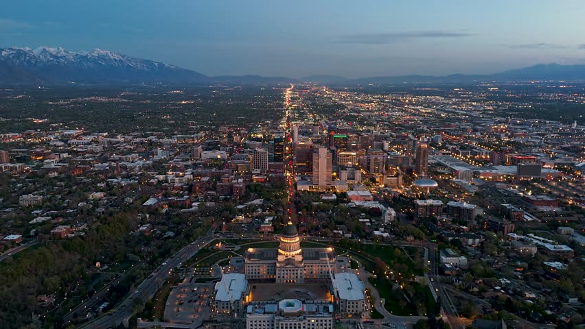 Moving drone shot of the Salt Lake City Capital building with the city scape in the background