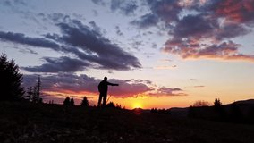 Slow motion silhouette of a person waving hand against the sunset - Powered by Shutterstock - Get 15% off with code: PIKWIZARD15