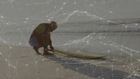 man crouching on sandy beach tying surfboard leash, with animated wave graphs showing technology. Seashore, leisure, adventure, coastal, outdoor, activity, lifestyle - Powered by Shutterstock - Get 15% off with code: PIKWIZARD15