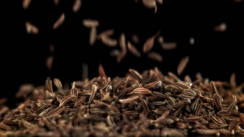 Cumin seeds fall on the table. Filmed on a high-speed camera at 1000 fps. High quality FullHD footage