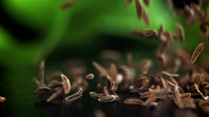 Cumin seeds fall on the table. Filmed on a high-speed camera at 1000 fps. High quality FullHD footage