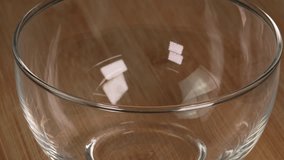 Coffee beans falling into glass bowl on wooden table in slow motion. Roasted coffee beans falling into bowl on wooden background - Powered by Shutterstock - Get 15% off with code: PIKWIZARD15