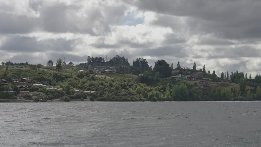 Cloudy Lake Landscape with Forested Hills in Chiloe