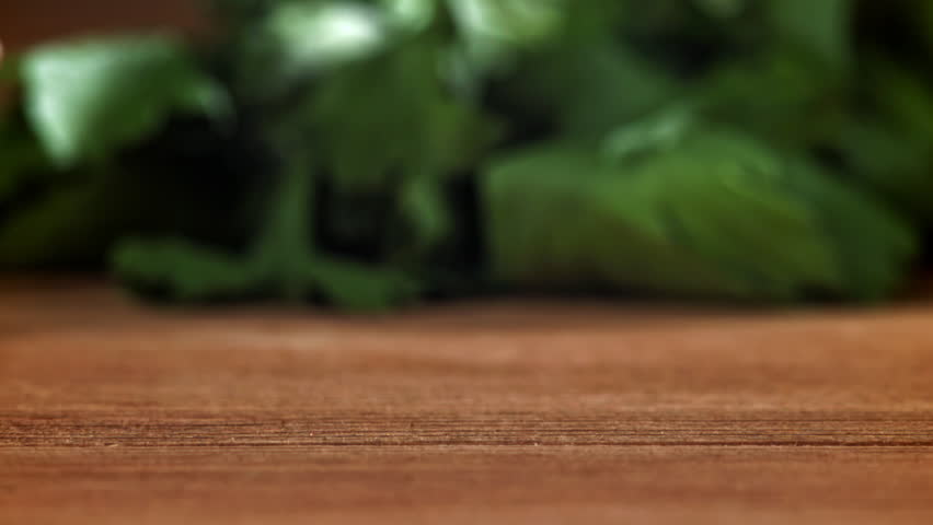 Coriander grains fall on a wooden table. Filmed on a high-speed camera at 1000 fps. High quality FullHD footage