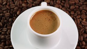 White coffee cup rotates on a saucer among roasted coffee beans, close up top view. Concept of coffee shop, market, store, presentation, advertising billboard - Powered by Shutterstock - Get 15% off with code: PIKWIZARD15