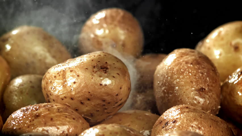 The potatoes are fried in a large frying pan. Filmed on a high-speed camera at 1000 fps. High quality FullHD footage