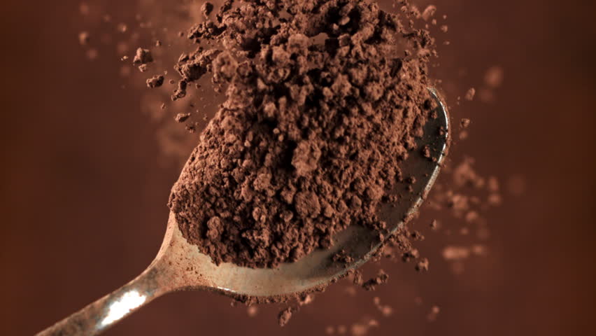 Cocoa powder falls from a spoon. Filmed on a high-speed camera at 1000 fps. High quality FullHD footage