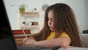 Online learn for kid using laptop. Young girl focused on virtual class. Child engaged in online learn. Digital education setup for girl. Girl learn online using laptop. Online learn activities for kid - Powered by Shutterstock - Get 15% off with code: PIKWIZARD15