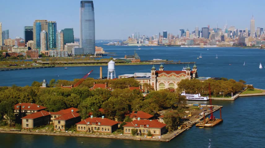 Aerial View of Ellis Island at Sunset – Historic Architecture, New York Harbor, and Cityscape with Liberty Island and Skyline