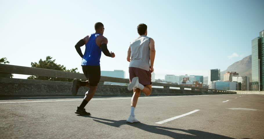 Men, friends and running on bridge for exercise with training for marathon, competition or race in city. Athlete, back and together for workout, challenge and fast for fitness on urban road in summer