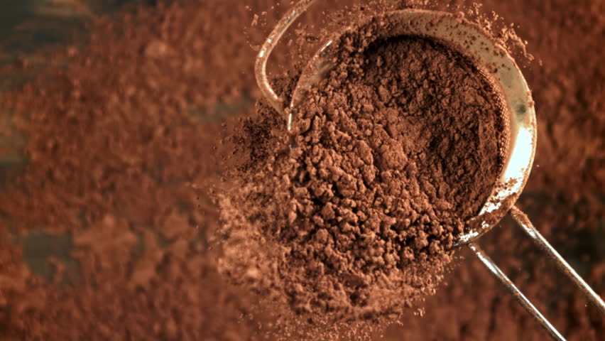 Cocoa powder is sifted through a sieve. Filmed on a high-speed camera at 1000 fps. High quality FullHD footage