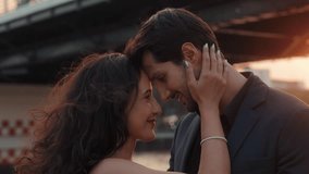 Portrait of lovely Latin American woman and man touch foreheads sailing yacht under bridge at sunset. Romantic moment between Hispanic partners bonding at sea journey in Thailand - Powered by Shutterstock - Get 15% off with code: PIKWIZARD15