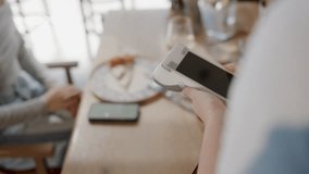 Waitress holding pos terminal while customer making contactless payment with smartphone in restaurant - Powered by Shutterstock - Get 15% off with code: PIKWIZARD15