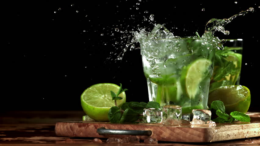Ice falls into a mojito cocktail. Filmed on a high-speed camera at 1000 fps. High quality FullHD footage