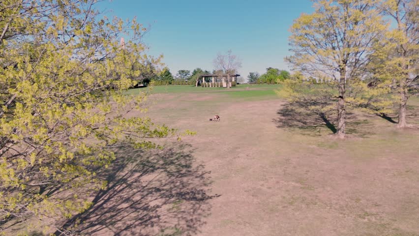 Aerial View of Peaceful Park with Blooming Spring Trees under clear blue skies. Beautiful Walnut Hill Park in New Britain, Connecticut. Outdoor Leisure Concept.