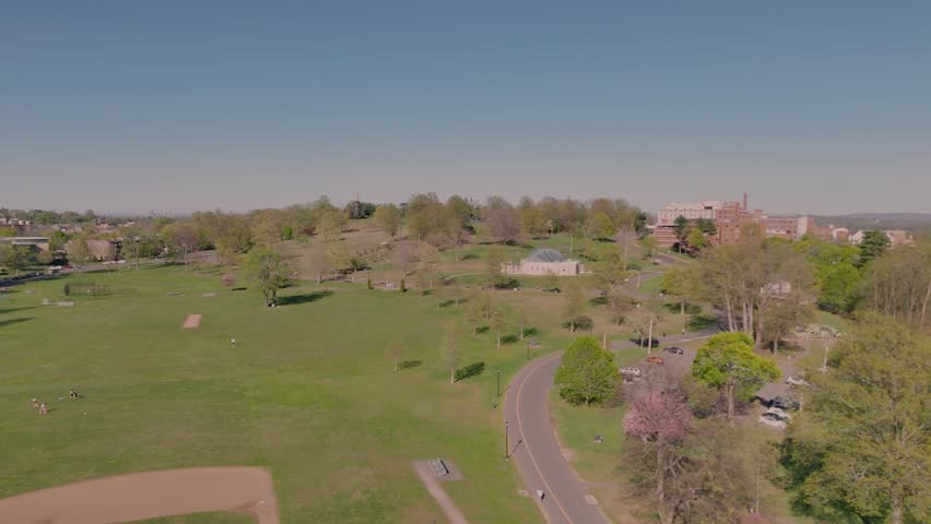 Aerial View of Peaceful Suburban Park on a Sunny Day. People Enjoy Outdoor Leisure and Sports at Walnut Hill Park in New Britain, Connecticut.
