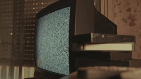 Vintage CRT TV with Static and VHS Tapes in Retro Room - Powered by Shutterstock - Get 15% off with code: PIKWIZARD15