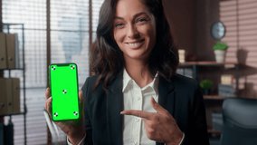 Happy Caucasian woman showing green screen mobile phone smartphone app online advertising female smiling businesswoman display mock up chroma key office girl pointing finger cellphone business indoor - Powered by Shutterstock - Get 15% off with code: PIKWIZARD15