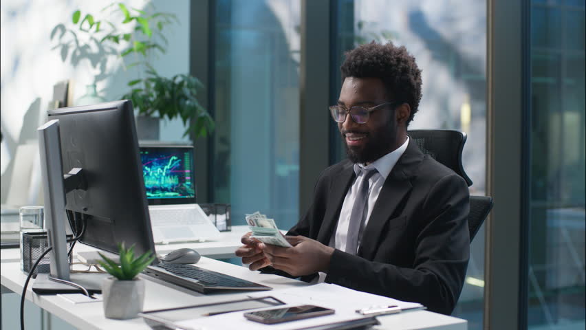Happy African American man businessman counting money banknotes salary male enjoy guy count cash success business finances manager wealthy rich employee entrepreneur in office profit earn investment