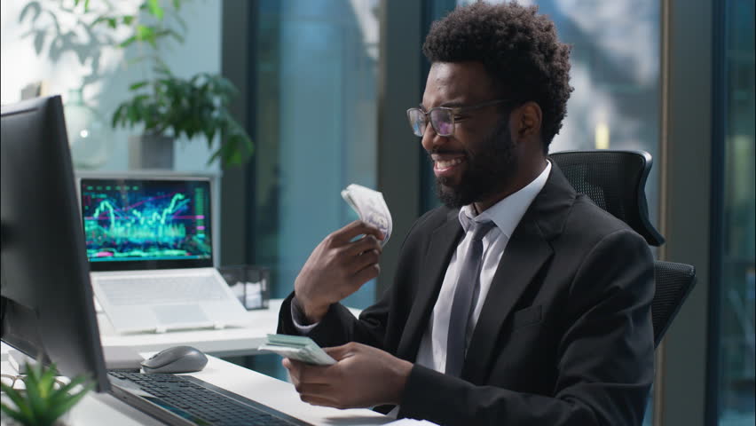 Happy African American man businessman counting money banknotes salary male enjoy guy count cash success business finances manager wealthy rich employee entrepreneur in office profit earn investment - Powered by Shutterstock - Get 15% off with code: PIKWIZARD15