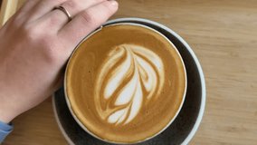 A cup of hot latte coffee on a wooden table taken using a high angle cafeine breakfast  - Powered by Shutterstock - Get 15% off with code: PIKWIZARD15