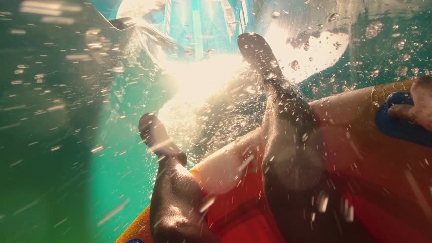 Dubai, UAE - 14th october, 2022: pov tourist visitors in aqua park in Dubai slide down pipe enjoy water park rides. United Arab Emirates. Extreme slides family activity outdoors
