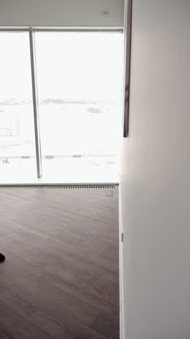 Mature woman standing near painting, deeply contemplating contemporary artwork with pensive expression in minimalist gallery setting