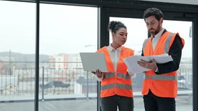 Professional architect and engineer review blueprints and discuss project details in office. Teamwork, collaboration, and construction planning. - Powered by Shutterstock - Get 15% off with code: PIKWIZARD15