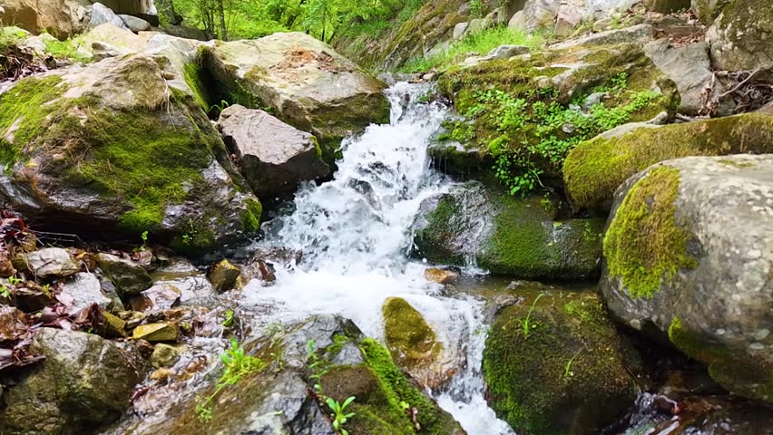 Valley for Summer Vacation ,Slow Motion ,Clear Stream flowing over rocks and rocks ,Rich Valley in slow motion ,Crystal clear water spills over rocks ,Silent natural scene ,Silent flowing riverbed