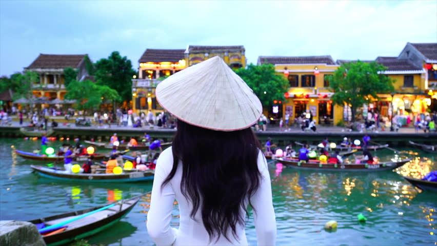 Asian woman wearing vietnam culture traditional at Hoi An ancient town,Hoi an city in Vietnam.