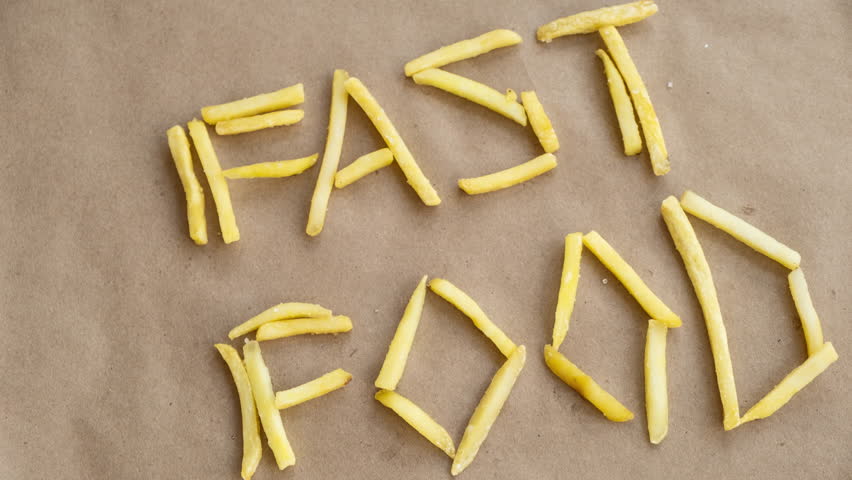 Stop motion animation. Fast food text is lined with french fries. 