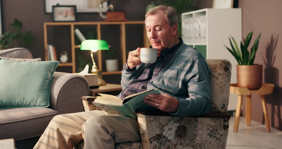 Coffee, senior man and book with reading for relax, knowledge and learning in retirement at home. House, male person and elder with novel for story, information and studying with tea drink at night