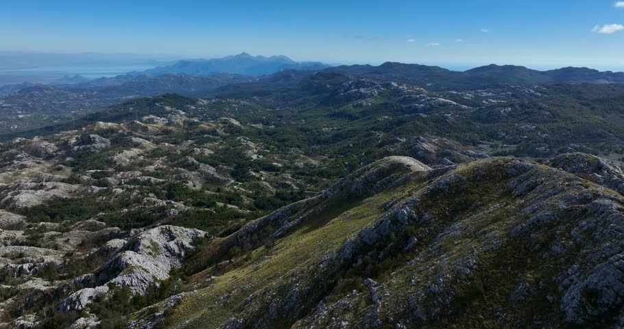 Mountain ridge in Lovćen, Montenegro with rocky terrain and distant sea view