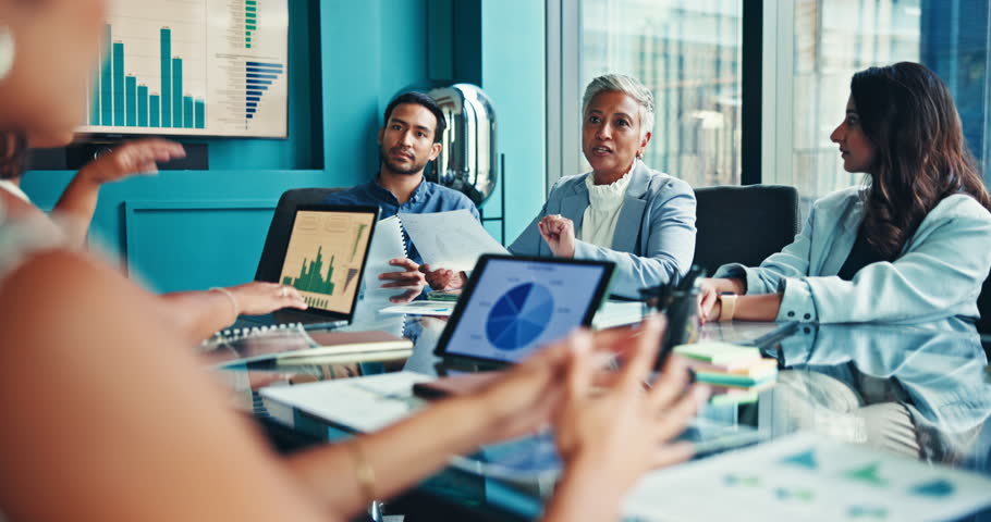 Business people, meeting and discussion with team for analytics, company performance or review. Group, employees or colleagues with technology or documents for analysis or statistics at conference