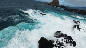 FPV drone flying along Porto Moniz coast, Madeira, over massive ocean waves crashing against cliffs. Aerial 4K footage for travel, adventure, nature and cinematic projects. Natural Swimming Pools - Powered by Shutterstock - Get 15% off with code: PIKWIZARD15