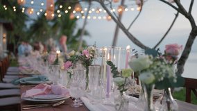 close up festive table setting flowers wedding party beach sunset.  Romantic dinner table decoration candles wedding reception. - Powered by Shutterstock - Get 15% off with code: PIKWIZARD15