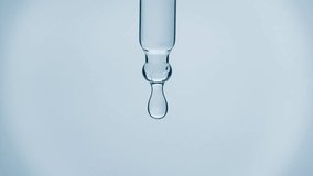 Cosmetics blue liquid dripping from laboratory glass pipette in super slow motion. Macro shot of drop hanging down from chemical dropper. Abstract body care serum ingredients formulating concept - Powered by Shutterstock - Get 15% off with code: PIKWIZARD15