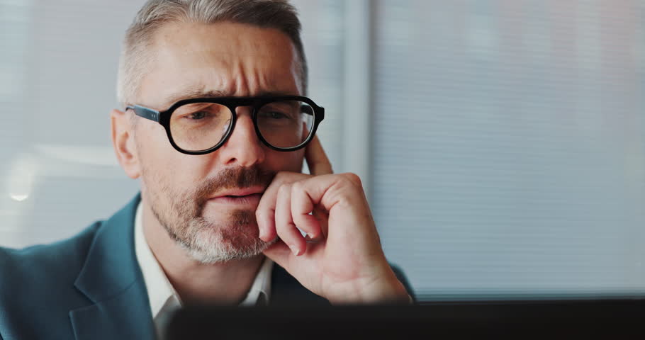 Worry, thinking and laptop with business man in office for reflection, debt portfolio and company bankruptcy. Liquidation, research and idea solution with employee in agency for account manager