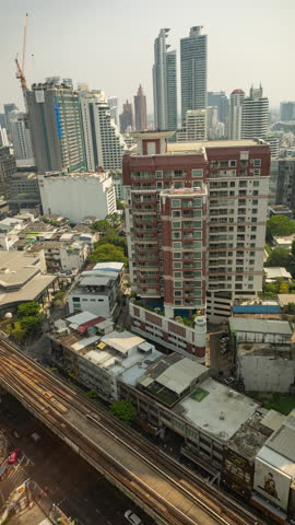 BANGKOK, THAILAND - 9 MARCH 2025 : timelapse of the Bangkok city skyline from a high vantage point in vertical