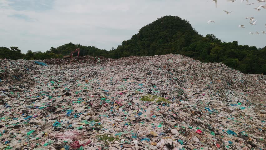 Aerial view of massive garbage on langkawi rainforest terrain, exposing critical environmental damage and ecosystem collapse