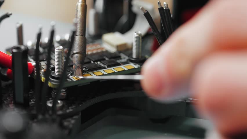 Technician soldering components onto circuit board of disassembled fpv drone - Powered by Shutterstock - Get 15% off with code: PIKWIZARD15
