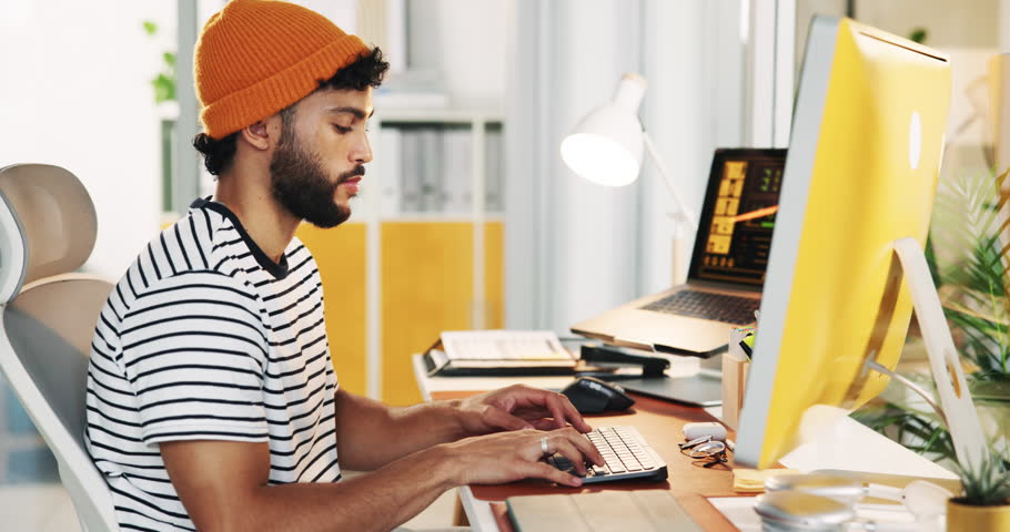Win, business man and celebrate on computer for success, goal or creative game designer typing in startup. Yes, achievement and happy worker in office with design approval or fist pump for promotion