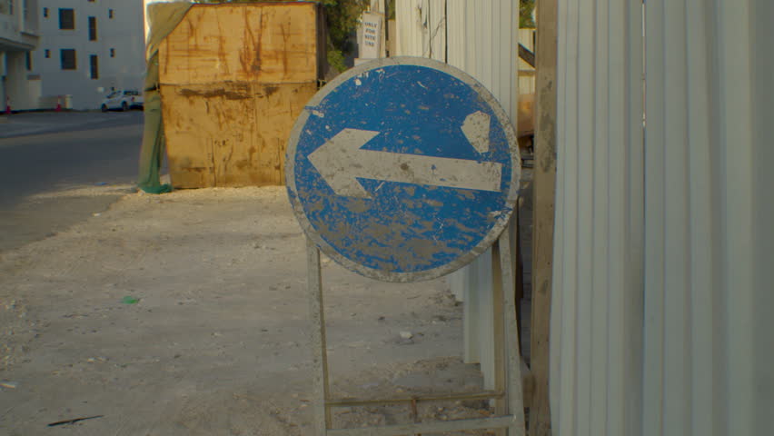 Arrow sign near construction site in Seef Area, Al Manāmah, Bahrain.