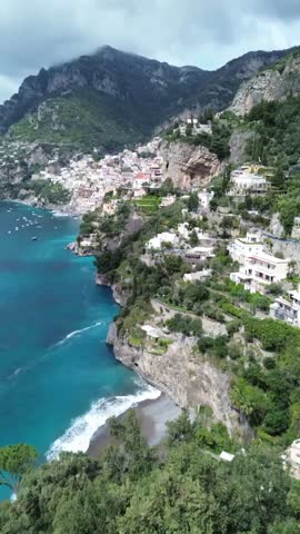 Aerial drone footage of Positano on the Amalfi Coast, showcasing colorful cliffside houses, turquoise waters, and iconic Mediterranean beauty in cinematic motion.