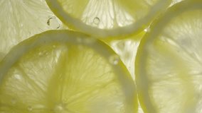 Drops of liquid falling on fresh sliced lemon pieces in slow motion. Beautiful ice water splash on lemon slices in macro. Vitamin C or serum acid in cosmetic product - Powered by Shutterstock - Get 15% off with code: PIKWIZARD15