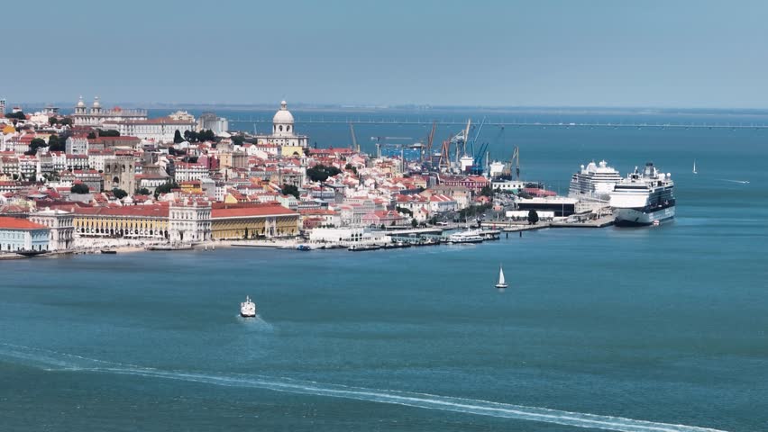Cruise ships docked at the terminal with a panoramic view of Lisbon’s historic waterfront and city buildings