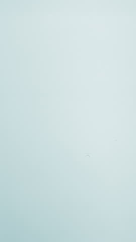 Natural mineral water splashing. Crystal clear drop of cosmetic essence serum falling in slow motion. Body moisturizing cosmetics formulating. Commercial beauty product blue liquid abstract background